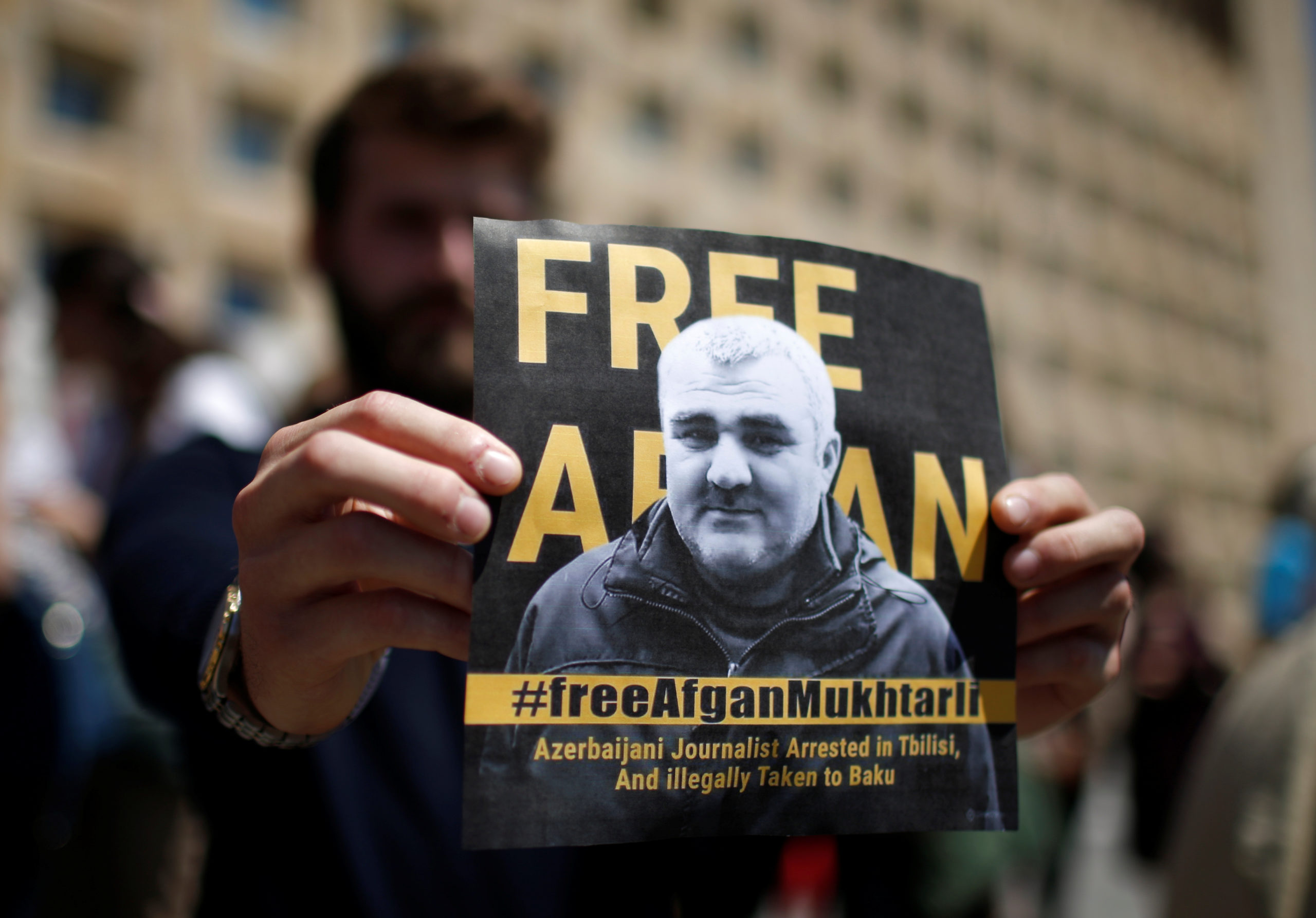 A man attends a rally to support an Azerbaijani Journalist Afgan Mukhtarli, who was abducted in Tbilisi on May 29 and now is in detention in Baku, in Tbilisi, Georgia May 31, 2017. REUTERS/David Mdzinarishvili