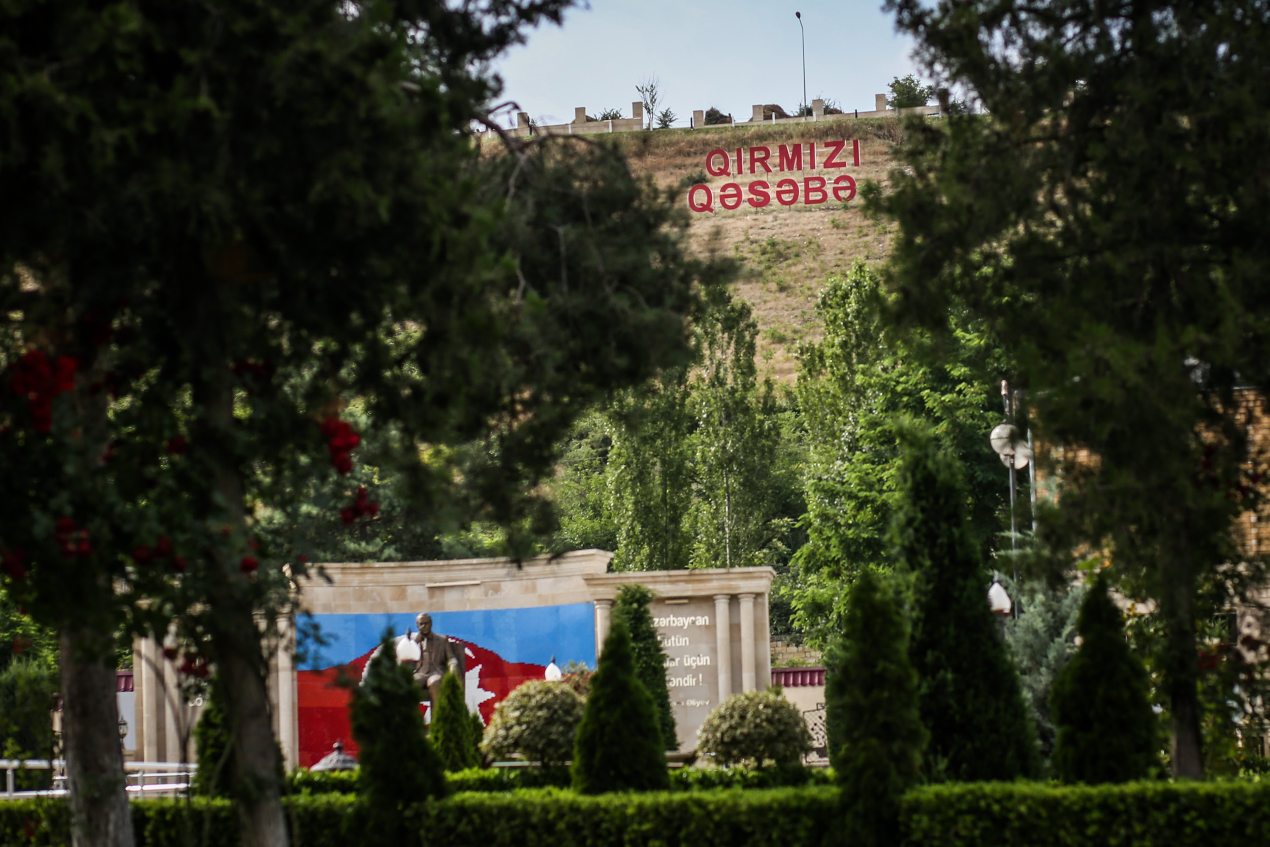 A welcome sign at the entrance of Qirmizi Qesebe, Red Village