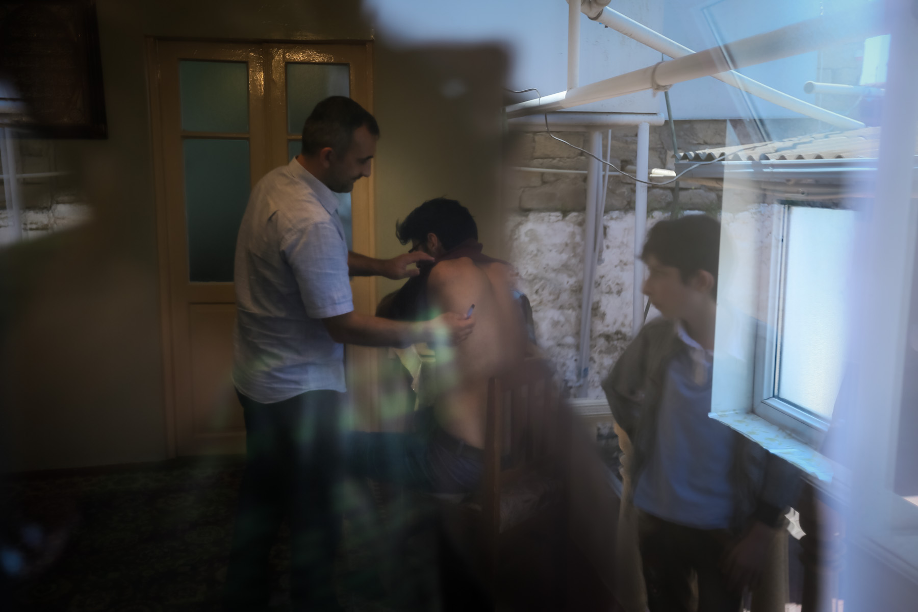 Aghaselim Childagh’s relatives perform the Childagh treatment in his home