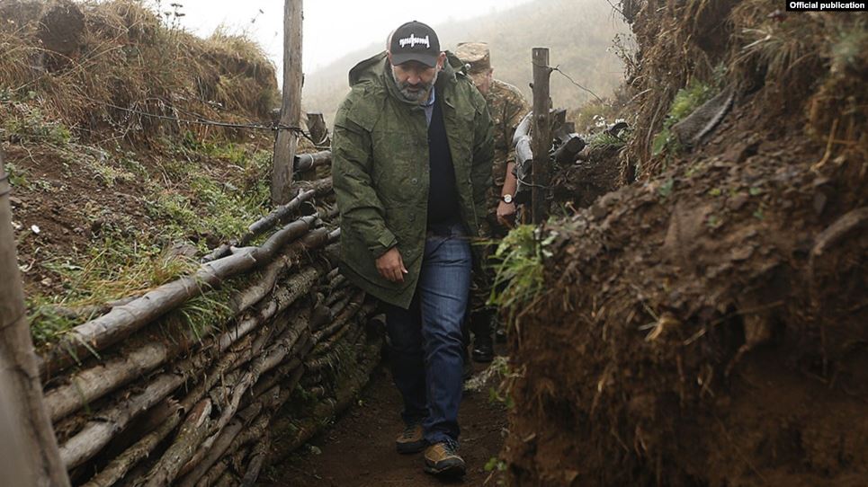 Armenian Prime Minister Nikol Pashinian walks through trenches in Nagorno-Karabakh on the “line of contact” with Azerbaijan during a visit in September.
