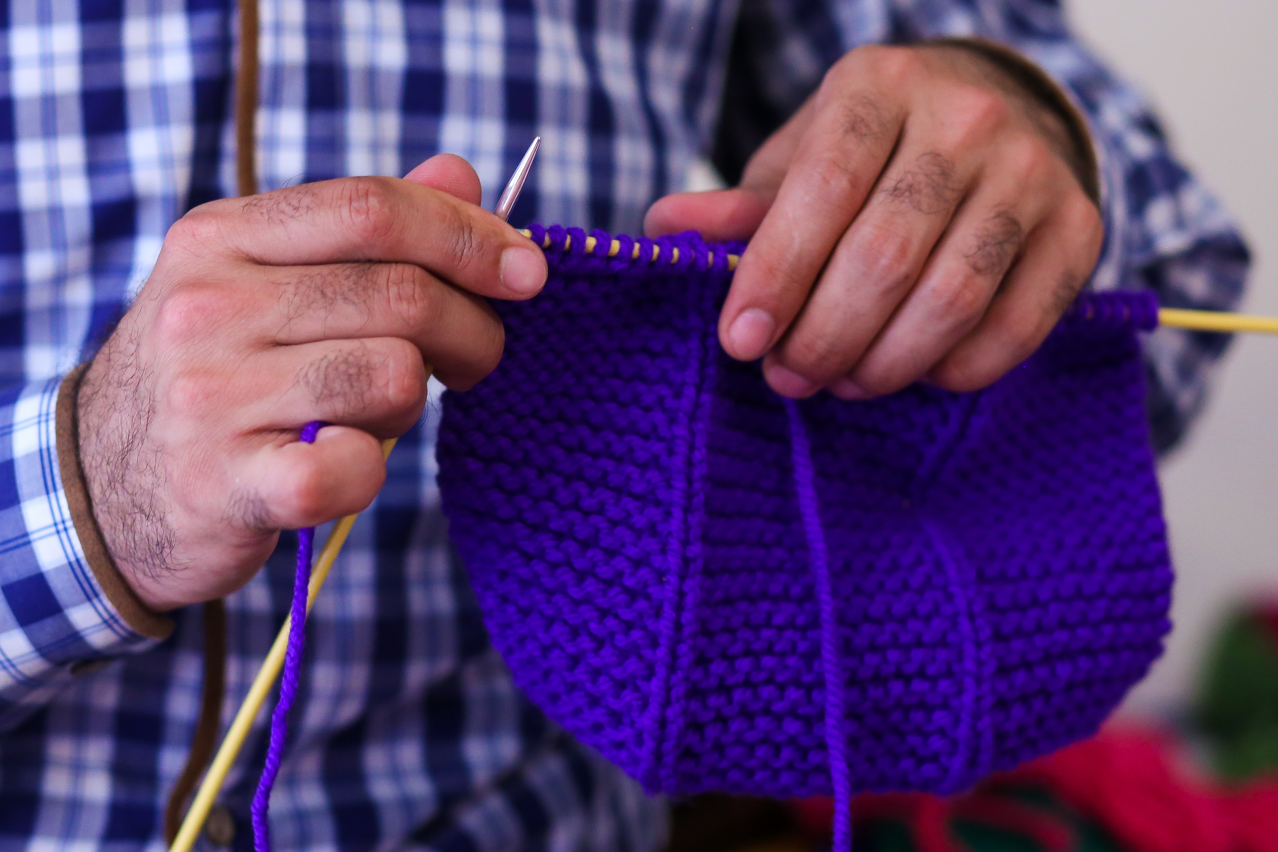 Aside from flowers, Elchin knits hats and scarves for children and adults