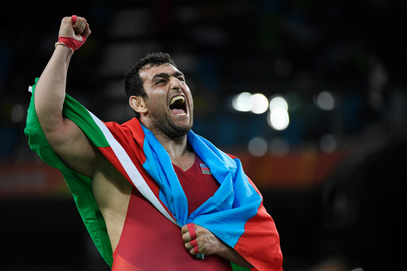 Sabah Shariati celebrates after pinning Eduard Popp of Germany to win the bronze
