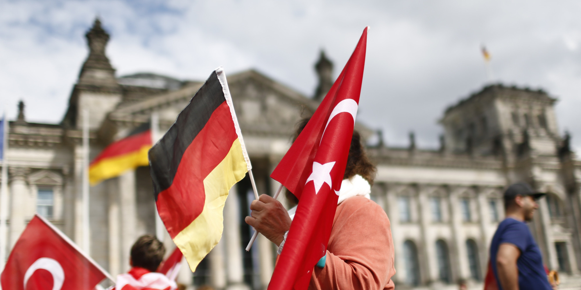 Demonstrators hold Turkish and German flags in front of the Reichstag, the seat of the lower house of parliament Bundestag in Berlin, Germany, June 1, 2016, as they protest against a disputed vote in Germany's parliament on Thursday, on a resolution that