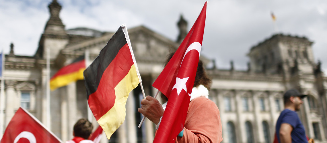 Demonstrators hold Turkish and German flags in front of the Reichstag, the seat of the lower house of parliament Bundestag in Berlin, Germany, June 1, 2016, as they protest against a disputed vote in Germany's parliament on Thursday, on a resolution that