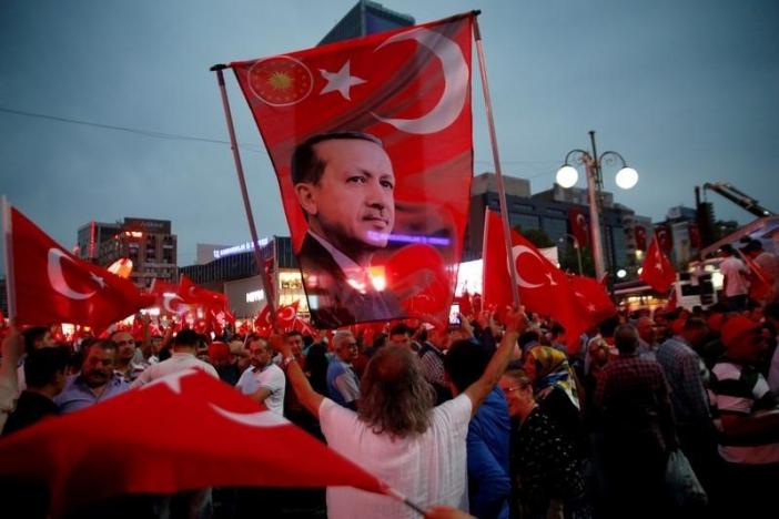 A supporter holds a flag depicting Turkish President Tayyip Erdogan during a pro-government demonstration in Ankara, Turkey, July 20, 2016. REUTERS/Baz Ratner/File Photo