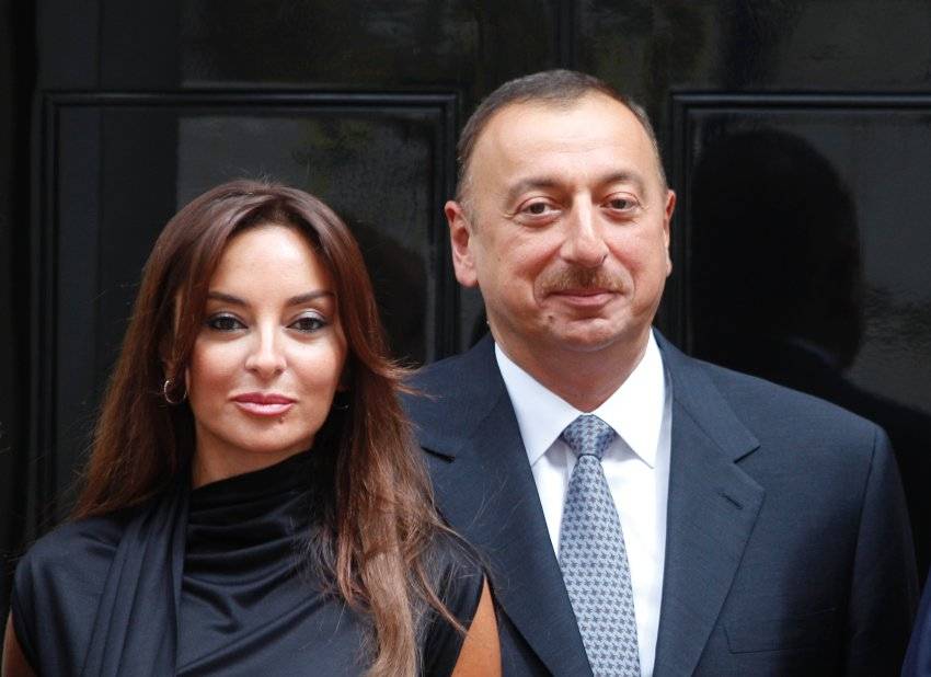 Azerbaijan President Ilham Aliyev, right, and his wife Mehriban Aliyeva, left, pose for the photographers outside British Prime Minister Gordon Brown's official residence at 10 Downing Street, in central London, following their meeting, Monday July 13, 20