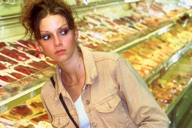 A female model poses as a shoplifter