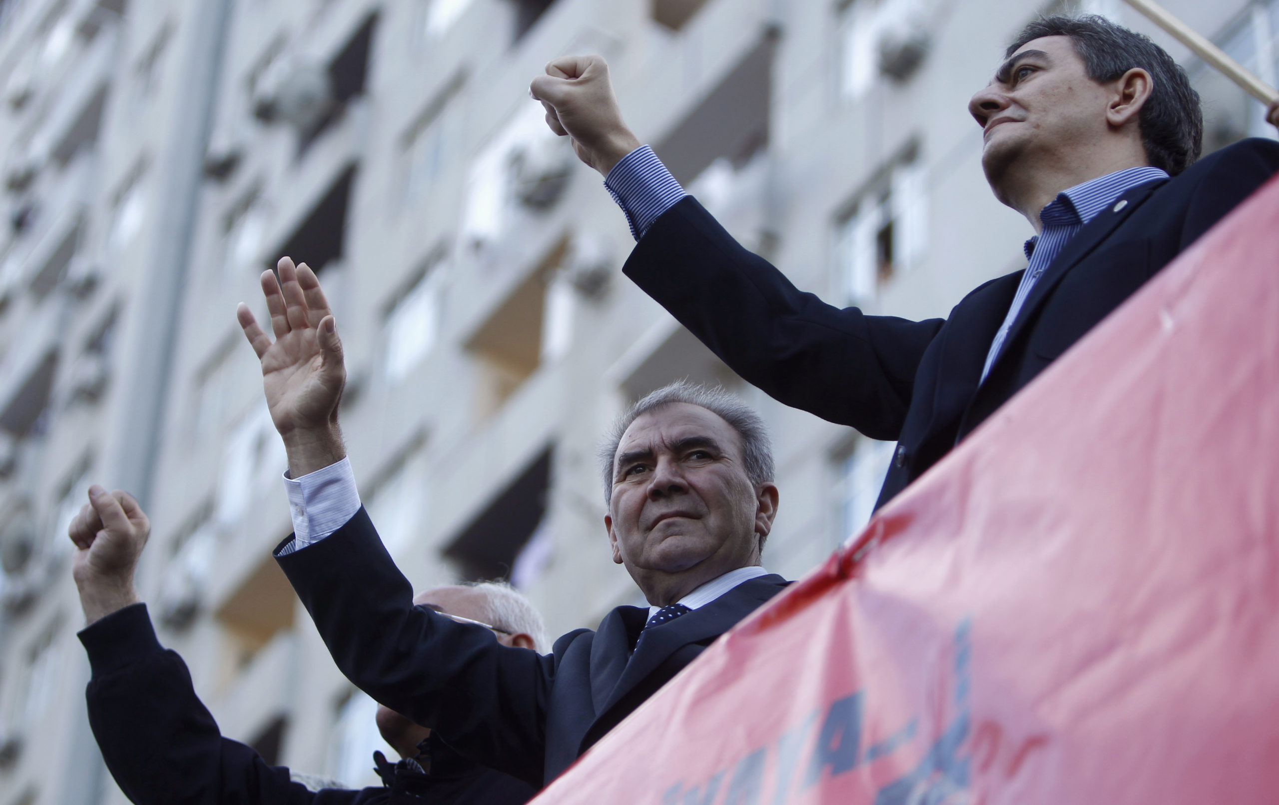 Jamil Hasanly (C), the presidential candidate from the united opposition and opposition leaders Ali Kerimli (R) and Isa Gambar greet supporters during a rally in Baku, October 12, 2013. Police beat and detained demonstrators after an opposition rally on S