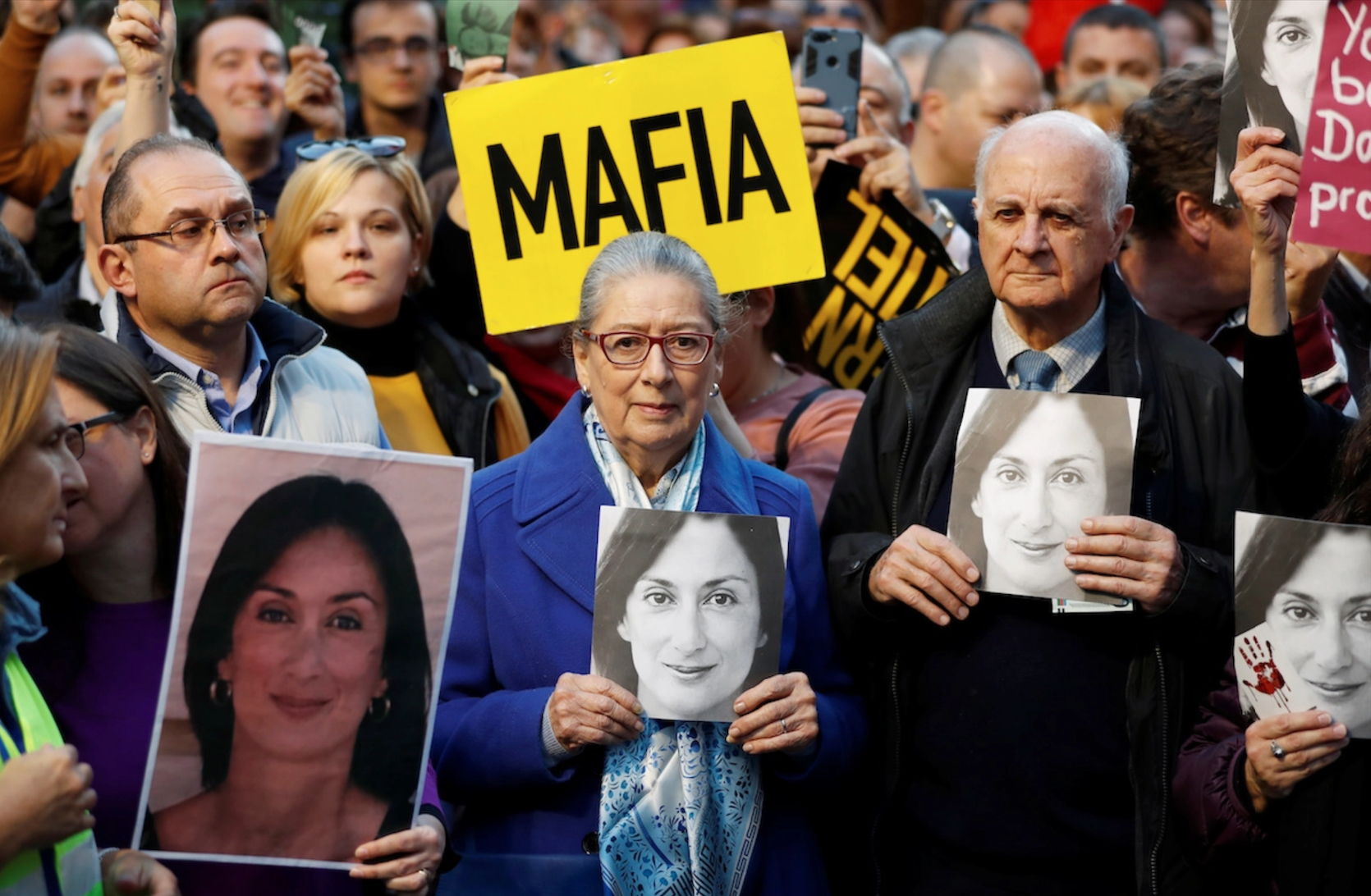 The mother and father of the murdered Daphne Galizia with portraits of their daughter in their hands at a protest in front of the Supreme Court in Valletta, Malta. December 1, 2019.